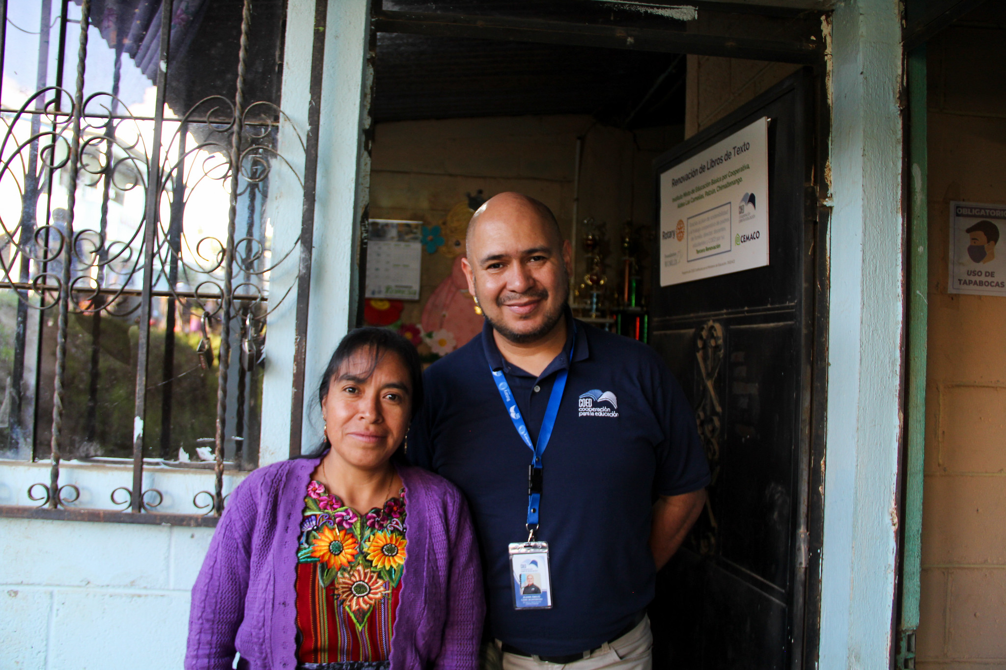 Alann, Field Representative and Teacher Trainer for the Textbook Program, with a teacher from Las Camelias